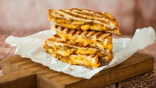 Grilled cheese sandwich kept atop a wooden platform