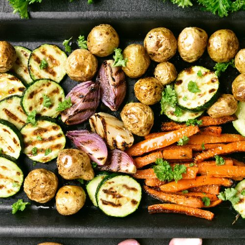 Grilled vegetables in a baking tray, top view