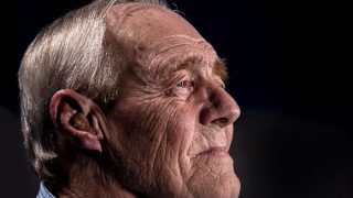 Older adult male with a hearing aid fitted