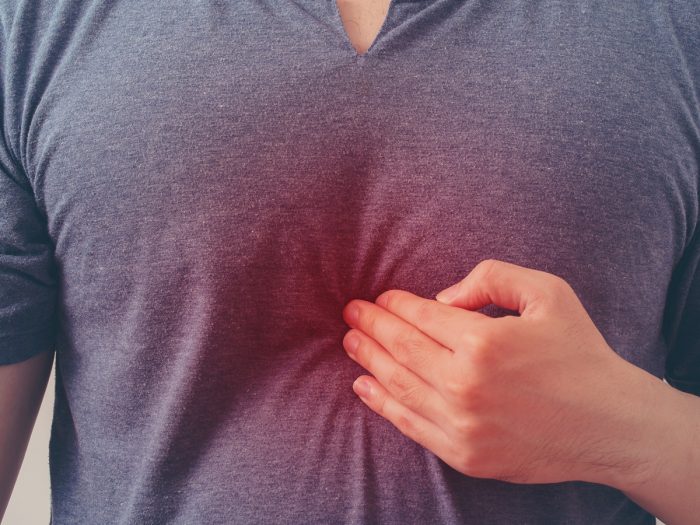 Close-up of a man pressing his chest.