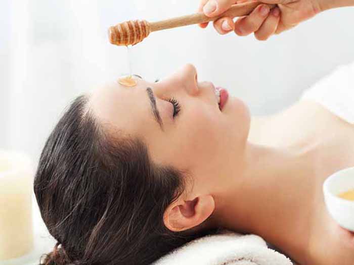 A woman getting a honey facemask at a spa or salon