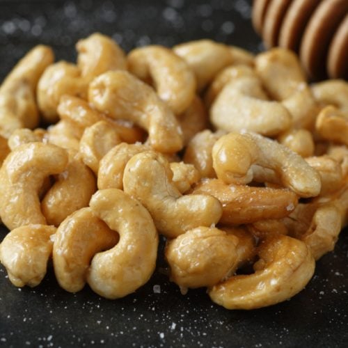 A closeup of honey roasted cashews on a kitchen table