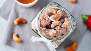 Honey roasted cashews on a grey background