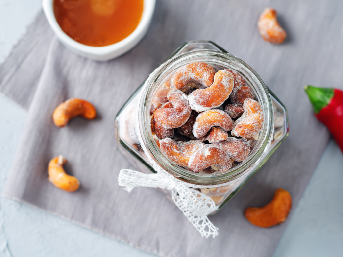 Honey roasted cashews on a grey background