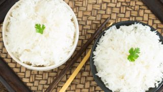 Thai jasmine rice or white rice in bowl on wooden Background