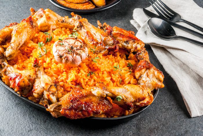 West African national cuisine such as jollof rice with grilled chicken wings and fried bananas plantains