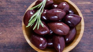 A flat lay pic of a bowl of kalamata olives