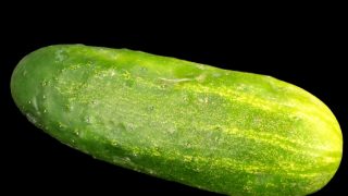 A Kirby cucumber against a dark background