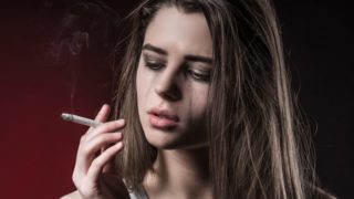 A girl crying while smoking