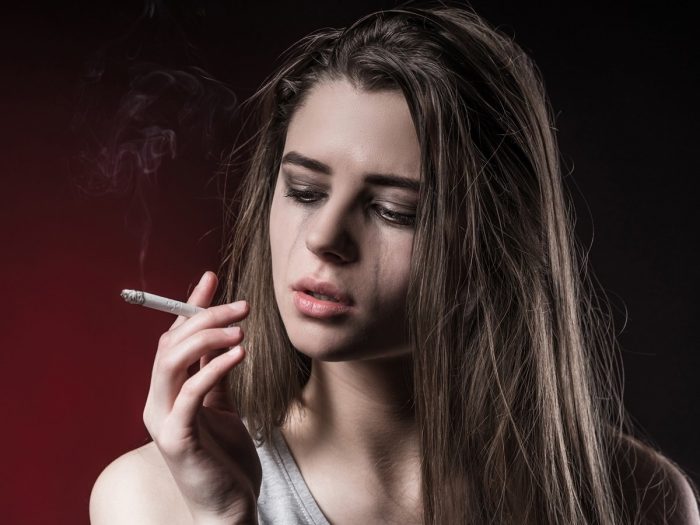 A girl crying while smoking