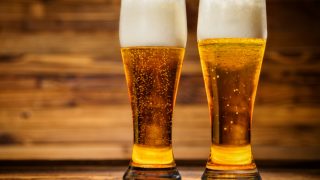 Two glasses filled with lager beer