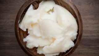A wooden bowl with lard on a wooden counter