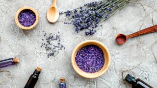 A flat-lay picture of lavender oil and lavender flowers
