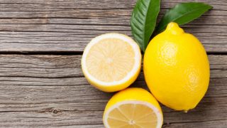 Fresh lemon and leaves on a wooden table