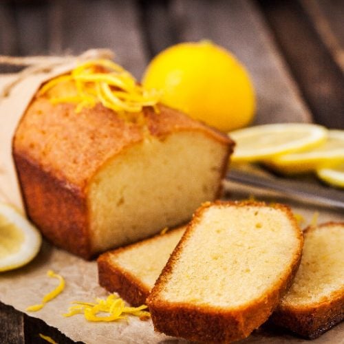 Lemon pound cake on rustic wooden background with lemon