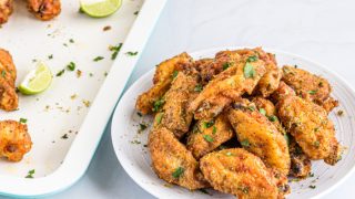 Crispy fried lemon pepper chicken wings on a white plate