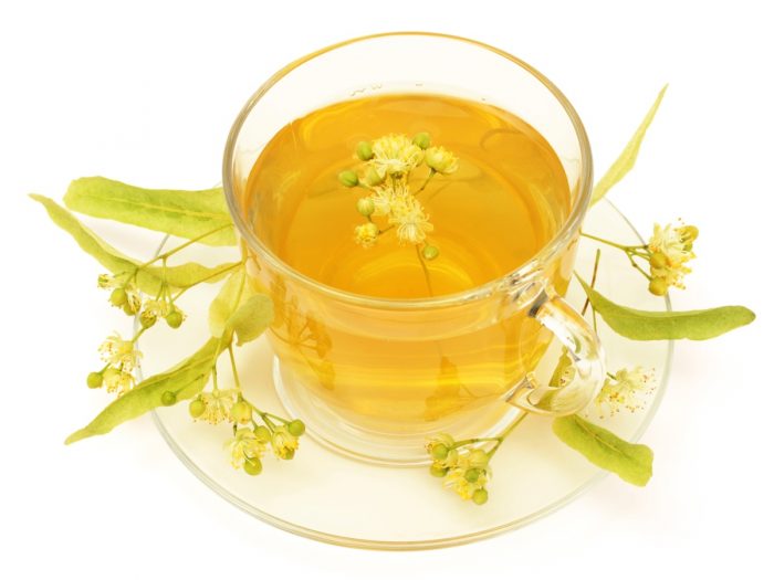 Glass cup and saucer with linden tea