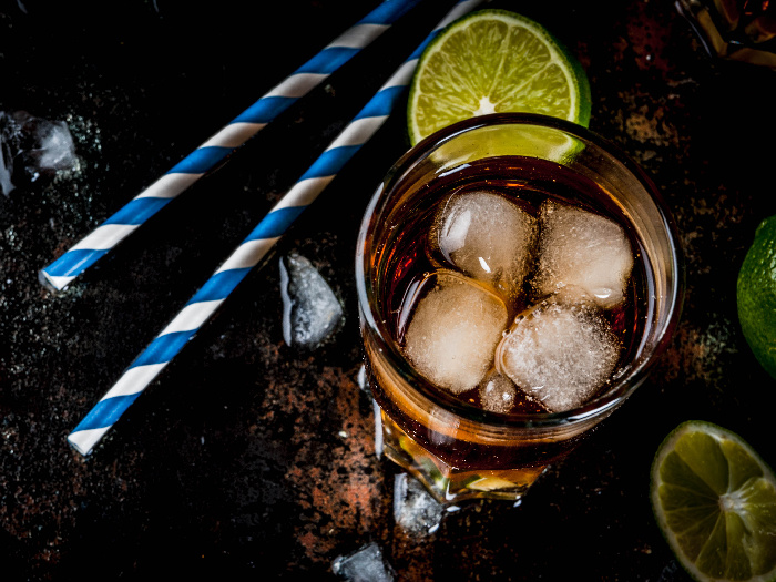 Long island or iced tea cocktails with hard liquor, cola, lime and ice