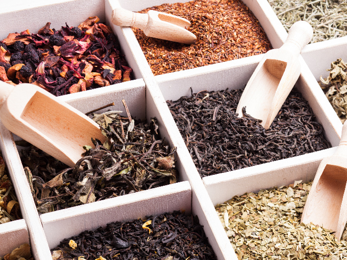 Various tea in a wooden box and scoops