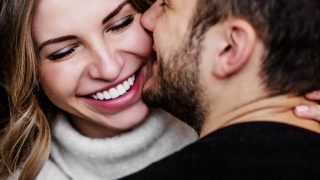 A man and woman, in love, hugging each other