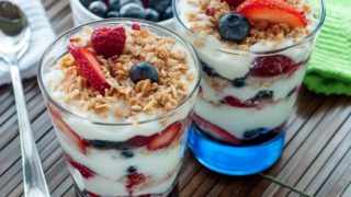Two glass of fruit parfaits on a table