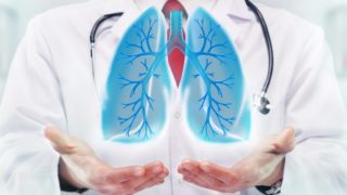 A doctor holding his palms out, holding an abstract image of lungs