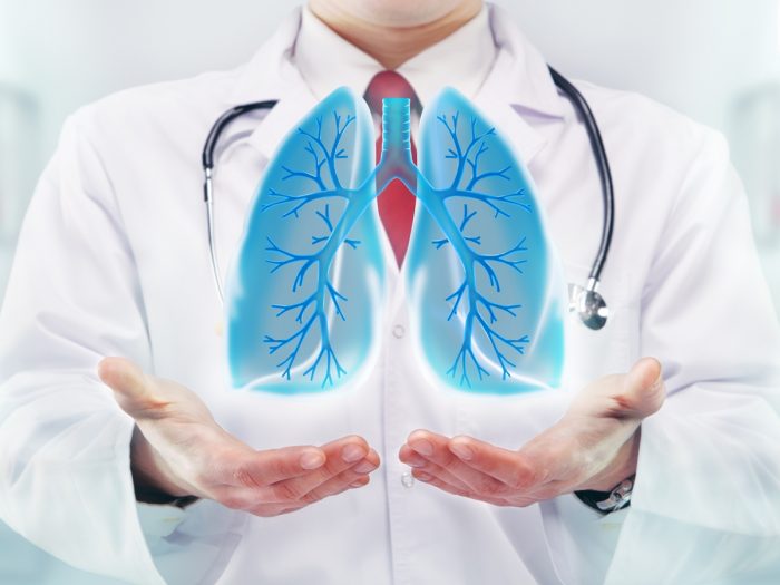 A doctor holding his palms out, holding an abstract image of lungs