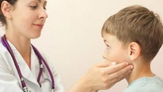 Young boy with the doctor suffering from lymph nodes went for the check-up at the hospital