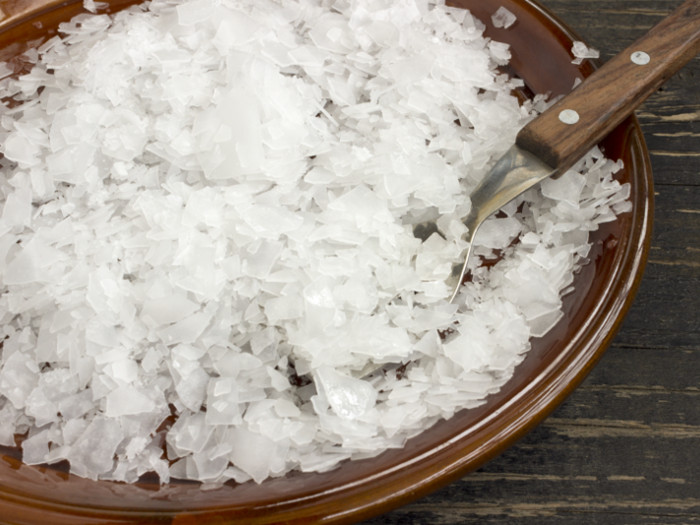 A close-up shot of a plate of magnesium chloride flakes