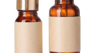 Close up of bottles of essential oil on a white background