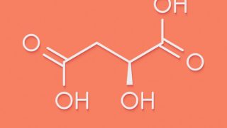 A chemical formula of malic acid on a peach background