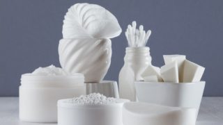 A counter top full of bathroom supplies in white color