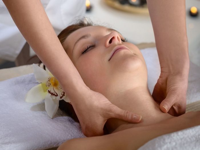 A young woman undergoing body massage in the spa