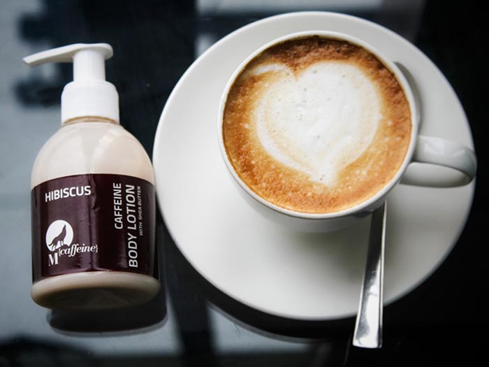 MCaffeine body lotion, next to a cappuccino