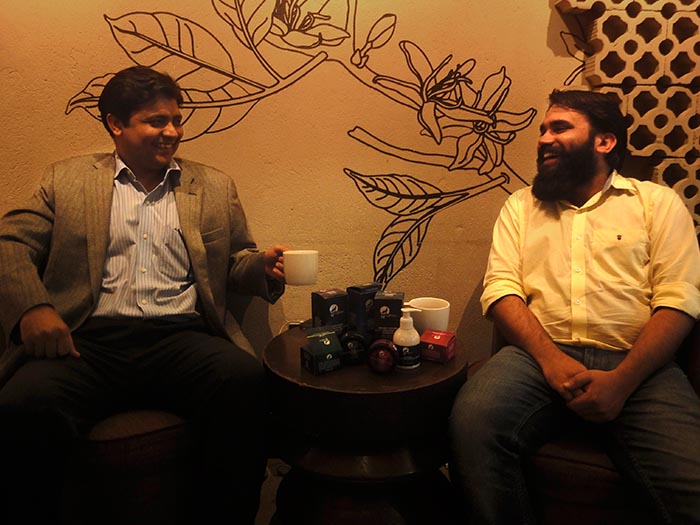 Vikas Lachhwani and Tarun Sharma, founders of MCaffeine, smiling at each other