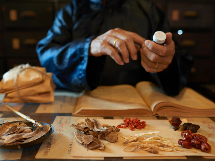 Close-up of hands of a practitioner making a remedy for his patient