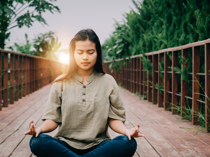 Asian girl practising meditation early in the morning