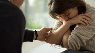 Woman being comforted by a therapist