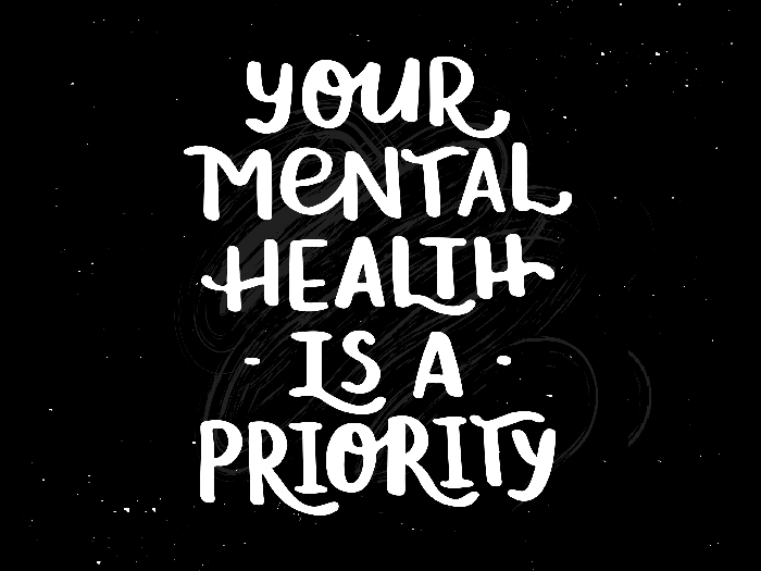 Hand drawn brush lettering on black background - Your mental health is a priority