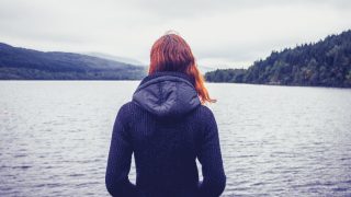 Depressed woman overlooking the lake