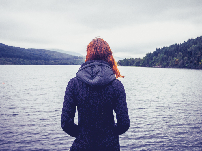Depressed woman overlooking the lake