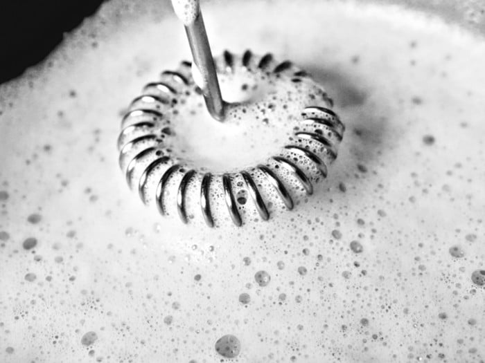 Close-up of a milk frother frothing milk