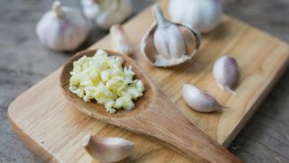 Minced garlic for cooking in a spoon