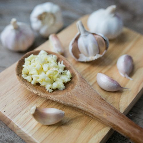 Minced garlic for cooking in a spoon