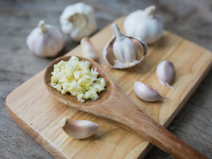 Minced garlic for cooking in a spoon