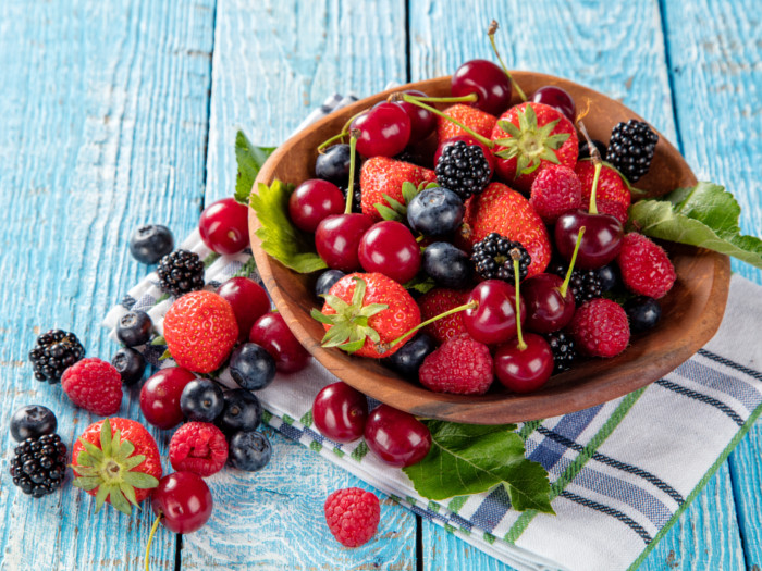 A bowl of mixed berries on a napkin