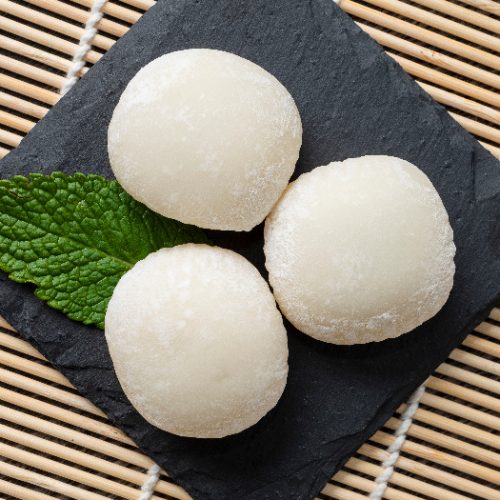 Japanese mochi ice cream with mint leaves on the wooden mat