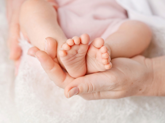 Hands holding a baby's feet
