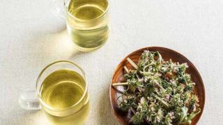 Two cups of motherwort teas kept next to a bowl of dried motherwort herbs on top of a white surface