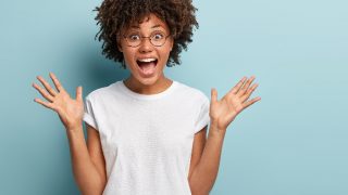 A girl gaping at the screen with happiness
